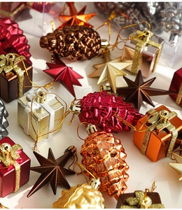 Assorted Christmas ornaments set with pine cones and gift boxes in festive metallic colors