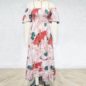 Detail of floral off-shoulder maxi dress featuring elastic bodice and tiered skirt layers