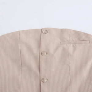Detail of apricot striped dress with three front buttons and a faux chest pocket