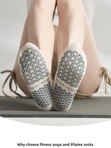 Macro shot of cotton yoga socks showing anti-slip silicone grip patterns on the sole