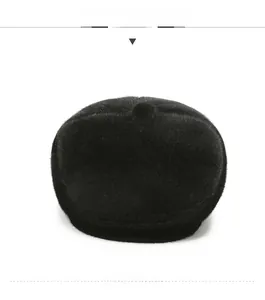 Front view of a thick black faux fur winter flat cap with earmuffs for cold protection