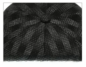 Macro detail of the striped fabric crown and stitched top button of the sun hat