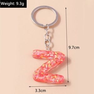 Detail showing letter Z keychain with pink sequins and dimension marks 9.7cm by 3.3cm