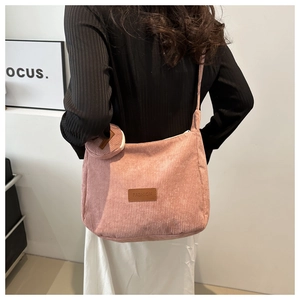 Pink corduroy crossbody tote bag with adjustable strap and matching round coin purse detail