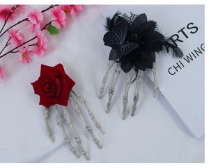 Detail of Gothic Halloween hair clips with skeleton hands, red roses and black lace