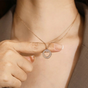Macro detail of a rose gold heart necklace with sparkling pavé cubic zirconia