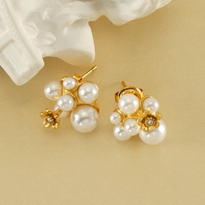 Elegant gold pearl cluster earrings featuring white pearls and a small gold flower detail