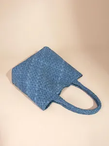 Handwoven blue denim texture tote bag with crossbody strap in a minimalist boxy shape