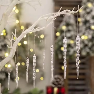 Set of clear acrylic icicle ornaments hanging on a white branch for Christmas tree decor