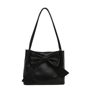 Large black tote bag with oversized bow detail and top handles for women