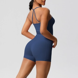 Cross-back detail of slim fit navy yoga romper with thin straps and open back design
