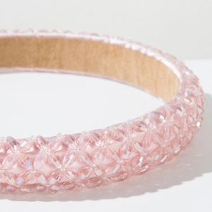 Close-up of pink crystal beaded headband showing detailed weave and satin finish