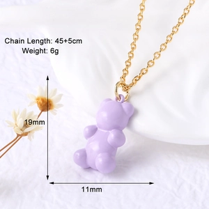 Macro view of gold chain with purple gummy bear pendant showing 45+5cm length detail