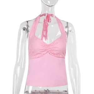 Detail of pink halter neck top featuring delicate lace patterns and lace-up neck ties