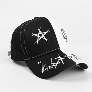 Detail of street-style baseball cap featuring black and white graffiti star patterns