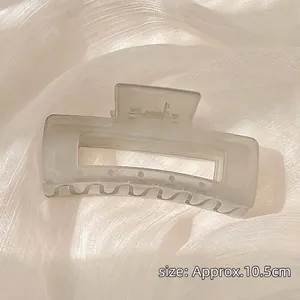 Detail of 10.5cm matte cream square hair claw clip on white silk background