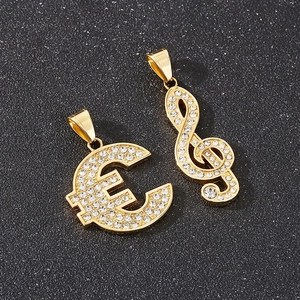 Macro shot of gold hip hop pendants featuring music note and Euro sign with full rhinestones
