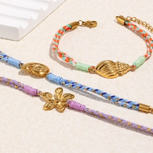 Lot de trois bracelets en cordon tressé avec coquillage et fleur plaqué or 18K
