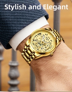 Close-up of golden skeleton mechanical watch with visible gears worn under a suit cuff