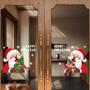 Detail of Santa Claus window stickers on glass with Happy New Year text decorations