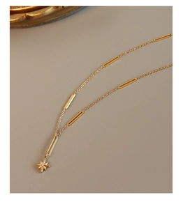 Detailed macro view of 18K gold plated hexagram star pendant and long bar link necklace