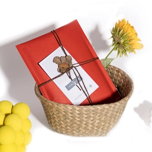 Eco-friendly red kraft paper bubble mailer with rustic twine and floral decoration