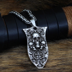 Close-up of Viking Yggdrasil pendant with skull shield design on dark textured fur