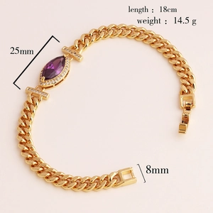 Detail view of gold-plated bracelet with purple marquise zircon and Cuban chain links