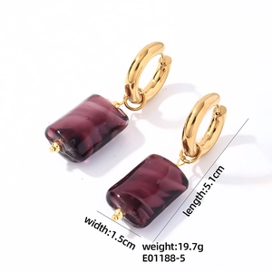 Detailed view of gold stainless steel earrings with purple stone and 5.1cm size specs