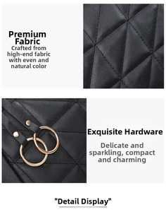 Close-up of black quilted fabric with diamond stitching and golden circular hardware