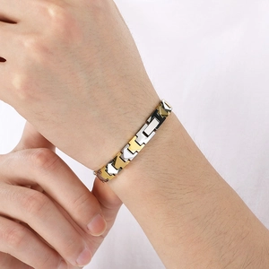 Two-tone gold and silver tungsten steel magnetic bracelet worn on a wrist for men and women