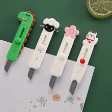 Detail shot of mini utility knives in cute dinosaur, sheep, flower and cat shapes