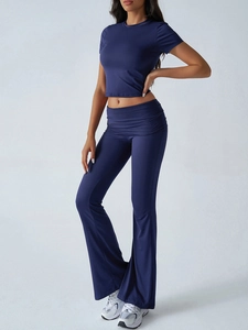 Detail view showing navy blue crop top and flared yoga pants set on a clean background