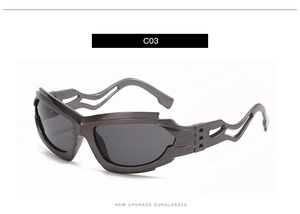 Detail view of futuristic dark grey sunglasses with cutout frame design in glossy finish