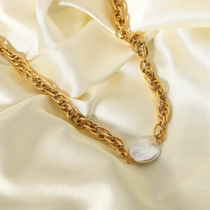 Detailed macro view of 18K gold plated chain necklace with a large baroque pearl