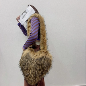 Detail of oversized heart-shaped faux fur shell bag with leopard print and wide strap
