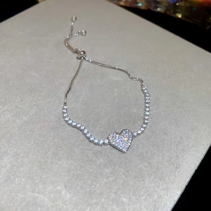 Detail view of silver heart pendant bracelet with micro-pave zircons and adjustable slider