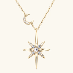 Macro detail of gold moon and star necklace with sparkling moissanite stones