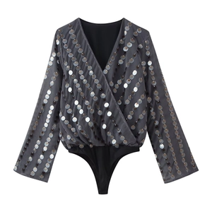 Charcoal grey V-neck bodysuit with long sleeves and shimmering sequins on white background