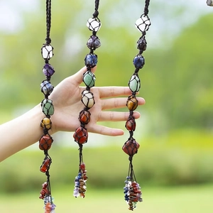 Detail of handmade seven chakra natural stones car pendant with braided net and crystal tassels