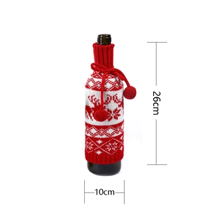 Detailed knit wine bottle cover with elk patterns and pom-poms measuring 26x10cm