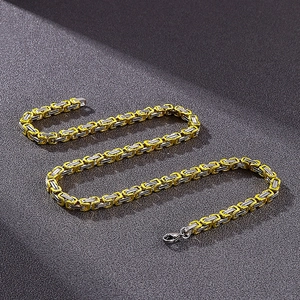 Close-up of 5mm two-tone gold and silver stainless steel Byzantine chain links