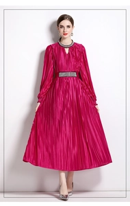 Detailed view of the fuchsia satin pleated dress with crystal waist and V-neck embellishments