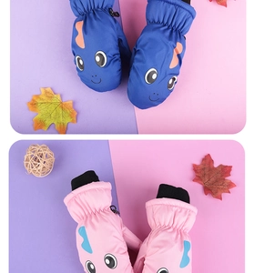 Detail view of colorful cartoon dinosaur mittens with waterproof fabric and warm cuffs