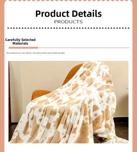 Detail of soft brown cow print flannel blanket texture with neat stitched edges on a chair