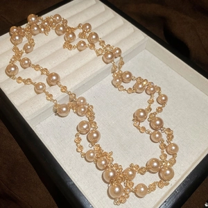 Detail of French vintage layered pearl necklace with champagne and amber glass beads