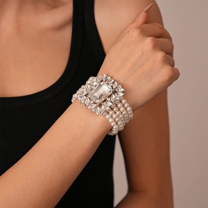 Close-up of a vintage multilayer pearl bracelet featuring a large crystal centerpiece