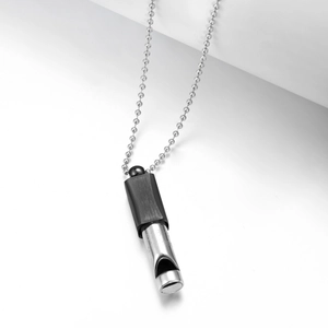 Detailed view of 528Hz meditation whistle pendant with black and silver finish and bead chain