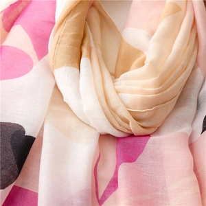 Detailed close-up of breathable cotton linen scarf with geometric pink and cream color blocks