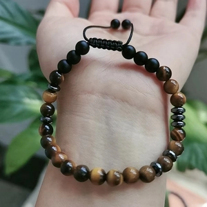Detailed shot of tiger eye beads and matte onyx stones on an adjustable soul sister bracelet
